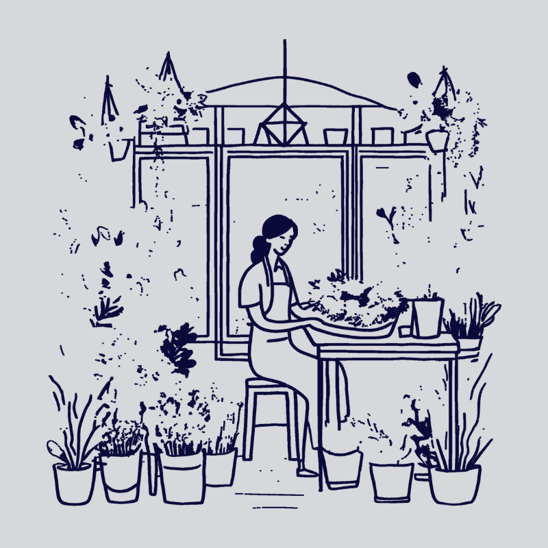 a woman at a table, surrounded by flowers